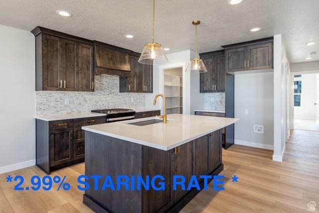 709 S 3575 W Unit 147, West Weber, UT 84401 - kitchen with range with gas cooktop, light wood-type flooring, dark brown cabinets, recessed lighting, and a textured ceiling