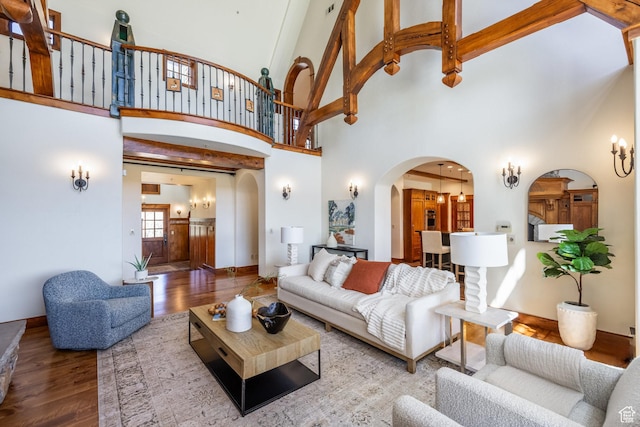 2000 W Red Hawk Trl, Park City, UT 84098 - living area with arched walkways, wood finished floors, a towering ceiling, and baseboards