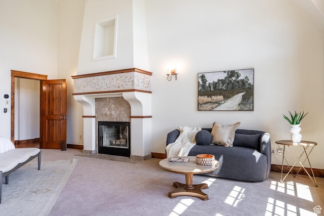 2000 W Red Hawk Trl, Park City, UT 84098 - carpeted living room featuring a towering ceiling, a tiled fireplace, and baseboards