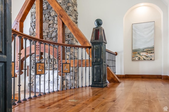 2000 W Red Hawk Trl, Park City, UT 84098 - stairway with wood finished floors, baseboards, a towering ceiling, and arched walkways