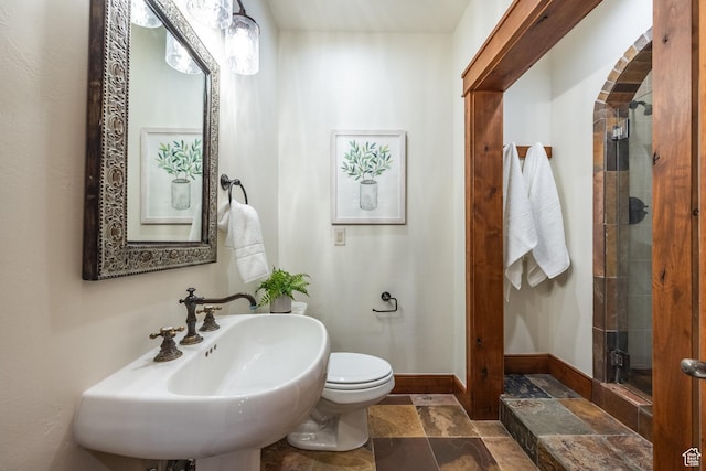 2000 W Red Hawk Trl, Park City, UT 84098 - full bathroom with stone tile flooring, a shower stall, toilet, a sink, and baseboards