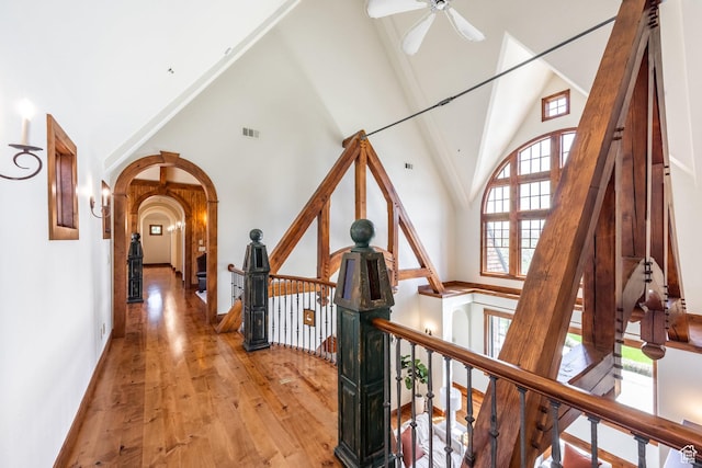 2000 W Red Hawk Trl, Park City, UT 84098 - hallway featuring an upstairs landing, high vaulted ceiling, arched walkways, wood finished floors, and baseboards