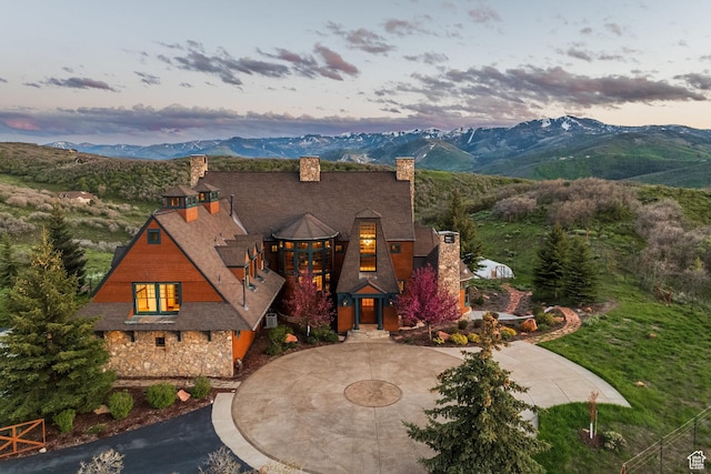 2000 W Red Hawk Trl, Park City, UT 84098 - view of front of home with curved driveway, a chimney, a mountain view, and stone siding