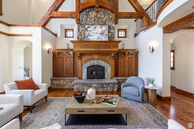 2000 W Red Hawk Trl, Park City, UT 84098 - living room featuring arched walkways, high vaulted ceiling, wood finished floors, baseboards, and beamed ceiling