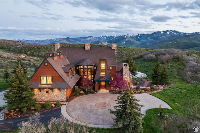 2000 W Red Hawk Trl, Park City, UT 84098 - view of front of property with a chimney, curved driveway, a mountain view, and stone siding