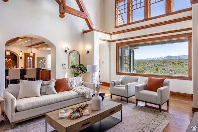 2000 W Red Hawk Trl, Park City, UT 84098 - living room with arched walkways, plenty of natural light, wood finished floors, baseboards, and a towering ceiling