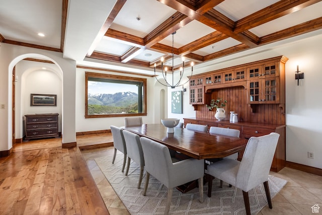 2000 W Red Hawk Trl, Park City, UT 84098 - dining area featuring arched walkways, baseboards, beamed ceiling, coffered ceiling, and crown molding