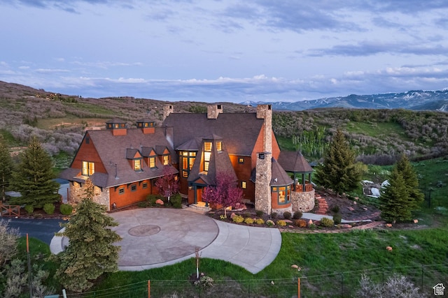 2000 W Red Hawk Trl, Park City, UT 84098 - view of front facade featuring a chimney, curved driveway, and a mountain view