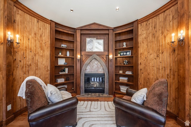 2000 W Red Hawk Trl, Park City, UT 84098 - living room with a fireplace, wooden walls, built in shelves, baseboards, and wood finished floors