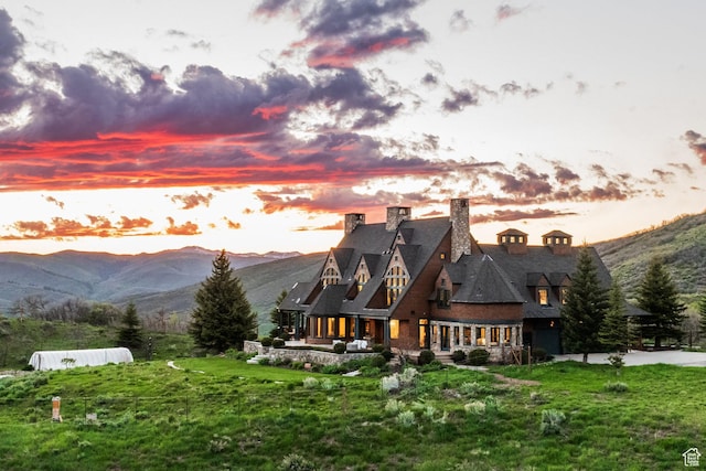 2000 W Red Hawk Trl, Park City, UT 84098 - back of house at dusk with a chimney and a mountain view