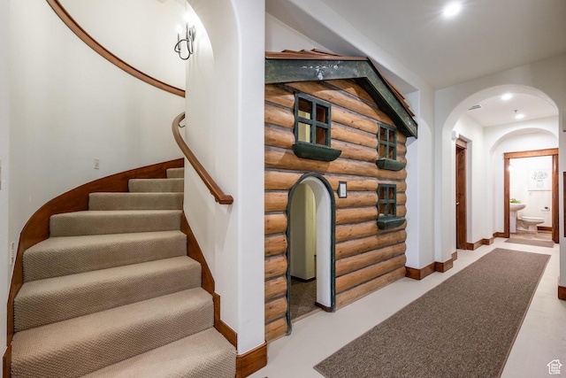 2000 W Red Hawk Trl, Park City, UT 84098 - staircase with rustic walls, arched walkways, and baseboards
