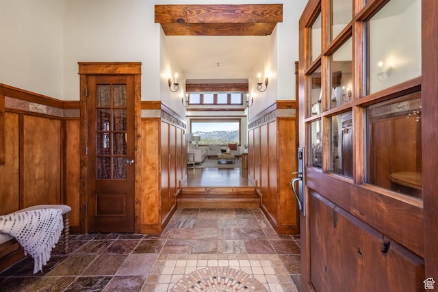 2000 W Red Hawk Trl, Park City, UT 84098 - entryway featuring stone tile flooring, a high ceiling, and wooden walls