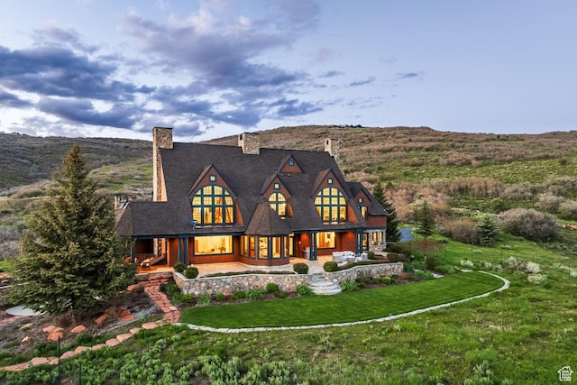 2000 W Red Hawk Trl, Park City, UT 84098 - back of house featuring a chimney, covered porch, and a yard