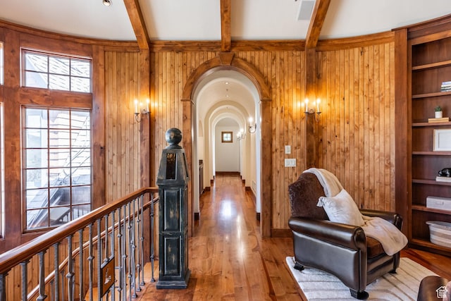2000 W Red Hawk Trl, Park City, UT 84098 - hallway with wood walls, beamed ceiling, an upstairs landing, wood finished floors, and arched walkways