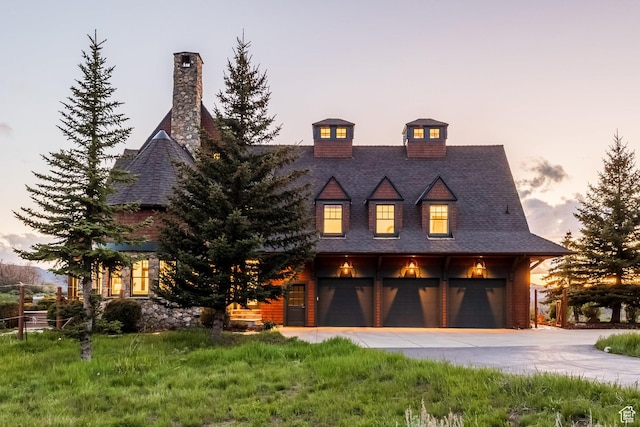 2000 W Red Hawk Trl, Park City, UT 84098 - view of front facade with concrete driveway, an attached garage, and a chimney