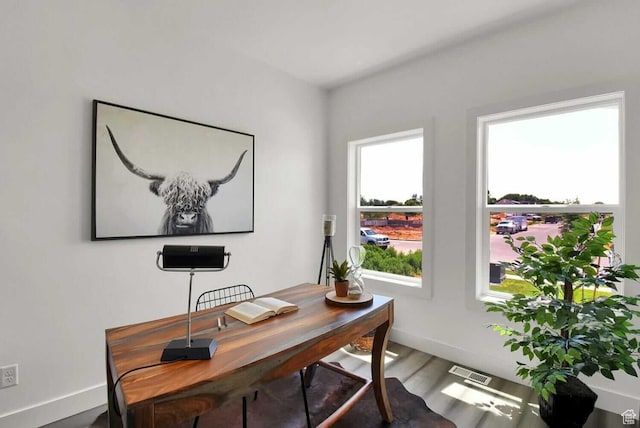 office space with baseboards and wood finished floors