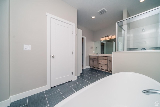 full bathroom with a shower stall, vanity, a soaking tub, baseboards, and recessed lighting