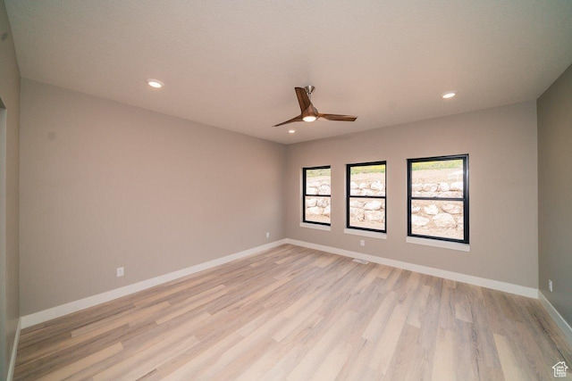 empty room featuring light wood-style floors, ceiling fan, recessed lighting, and baseboards