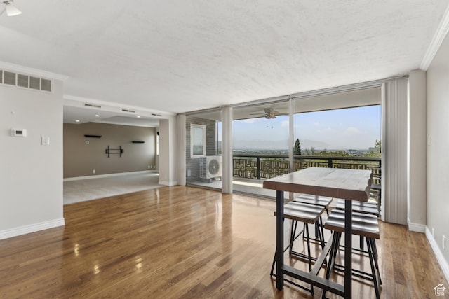 515 S 1000 E Unit 202, Salt Lake City, UT 84102 - unfurnished dining area featuring a ceiling fan, floor to ceiling windows, healthy amount of natural light, baseboards, and wood finished floors