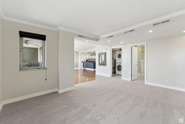 515 S 1000 E Unit 202, Salt Lake City, UT 84102 - unfurnished living room featuring stacked washer / drying machine, carpet flooring, crown molding, recessed lighting, and baseboards