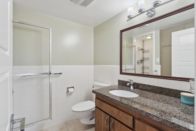 515 S 1000 E Unit 202, Salt Lake City, UT 84102 - bathroom featuring a shower stall, toilet, vanity, tile walls, and wainscoting