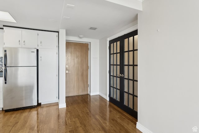 515 S 1000 E Unit 202, Salt Lake City, UT 84102 - kitchen featuring freestanding refrigerator, wood finished floors, white cabinetry, and baseboards