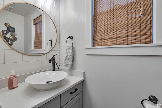 bathroom featuring tasteful backsplash and vanity