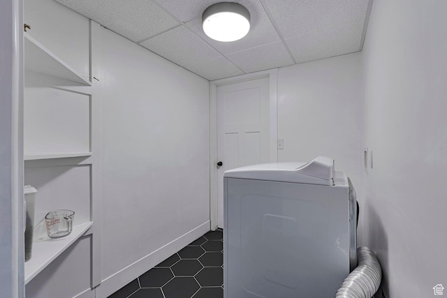 laundry area with washer / dryer and dark tile patterned floors