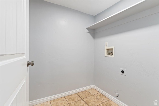 clothes washing area featuring hookup for an electric dryer, hookup for a washing machine, baseboards, and light tile patterned floors