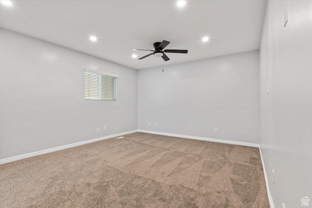 carpeted spare room with ceiling fan, baseboards, and recessed lighting