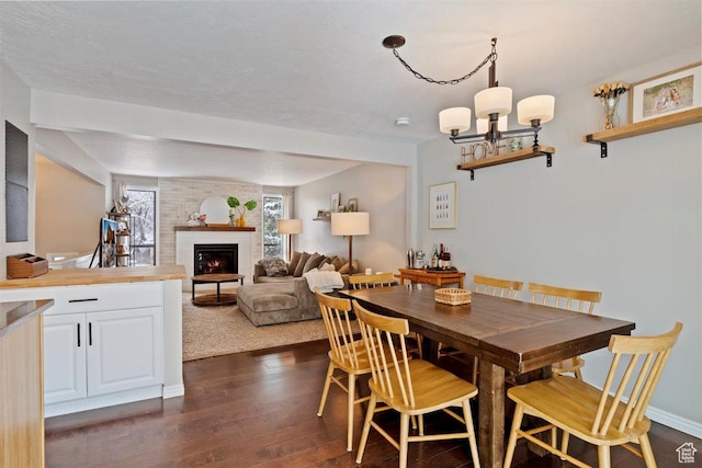 384 W 4200 N, Pleasant View, UT 84414 - dining area with dark wood-type flooring, a brick fireplace, and a chandelier