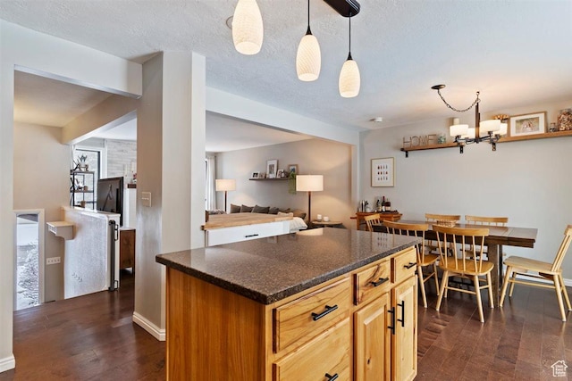384 W 4200 N, Pleasant View, UT 84414 - kitchen with dark wood-style flooring, decorative light fixtures, open floor plan, and a kitchen island