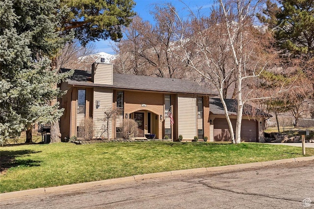 384 W 4200 N, Pleasant View, UT 84414 - view of front of property featuring a chimney, a front lawn, an attached garage, and concrete driveway