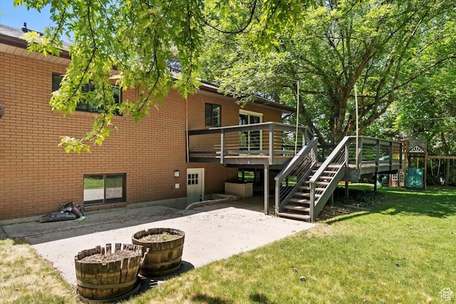 384 W 4200 N, Pleasant View, UT 84414 - rear view of house with a yard, a patio area, brick siding, and a wooden deck
