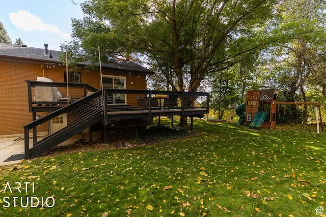 384 W 4200 N, Pleasant View, UT 84414 - rear view of house featuring a playground, a yard, a wooden deck, brick siding, and stairs