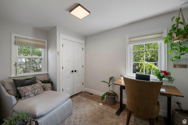 office area with light wood finished floors and baseboards