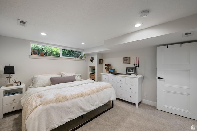 bedroom with light carpet, recessed lighting, and baseboards