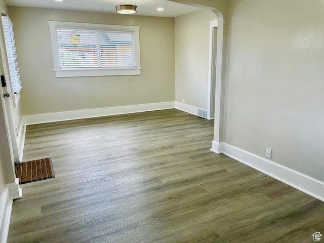 936 E Atkin Ave, Salt Lake City, UT 84106 - empty room featuring arched walkways, baseboards, and wood finished floors