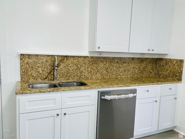 936 E Atkin Ave, Salt Lake City, UT 84106 - kitchen with stainless steel dishwasher, a sink, light stone countertops, white cabinets, and backsplash