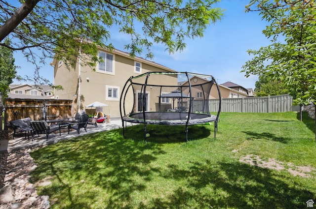 view of yard featuring a trampoline, a patio area, and a gazebo