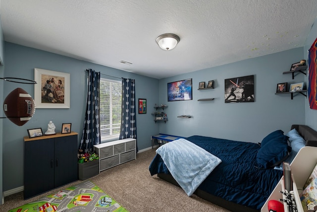 bedroom with carpet, baseboards, and a textured ceiling
