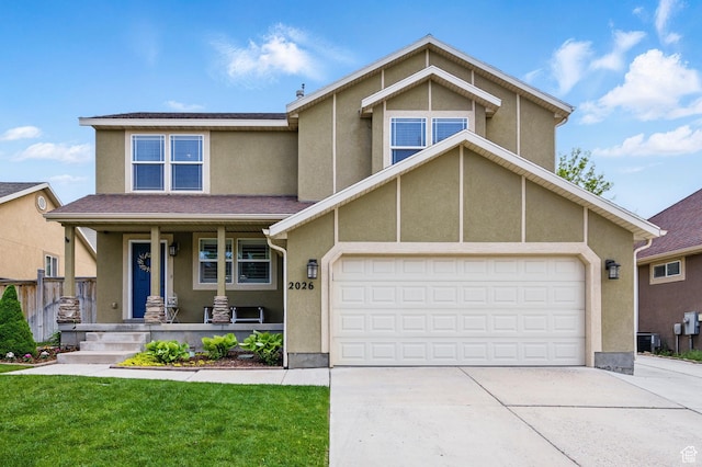view of front of property with covered porch, concrete driveway, stucco siding, a garage, and a front lawn