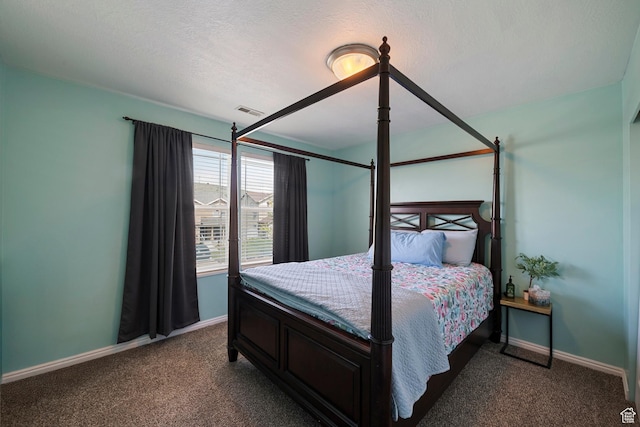 bedroom with carpet, baseboards, and a textured ceiling