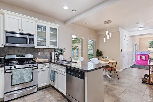 1026 N Shepard Creek Pkwy W Unit 10, Farmington, UT 84025 - kitchen with appliances with stainless steel finishes, a sink, decorative backsplash, a peninsula, and white cabinets