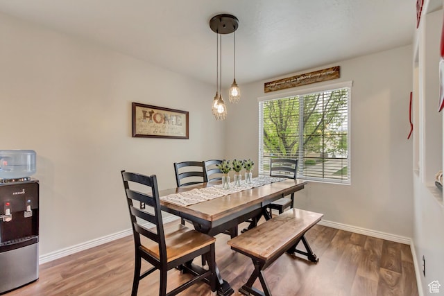 dining area with wood finished floors and baseboards