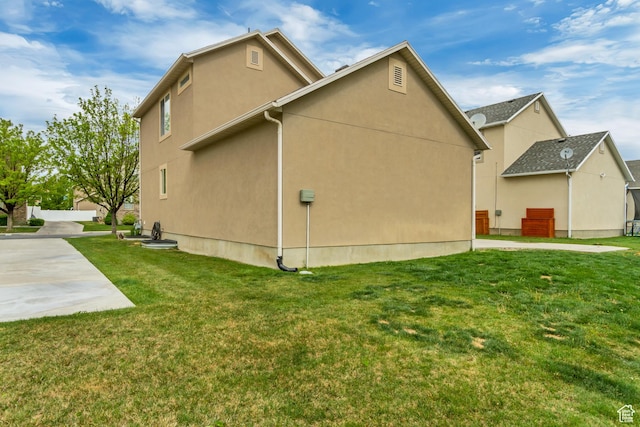 view of property exterior with a yard and stucco siding