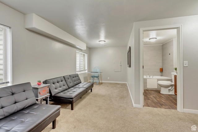 carpeted living room with baseboards