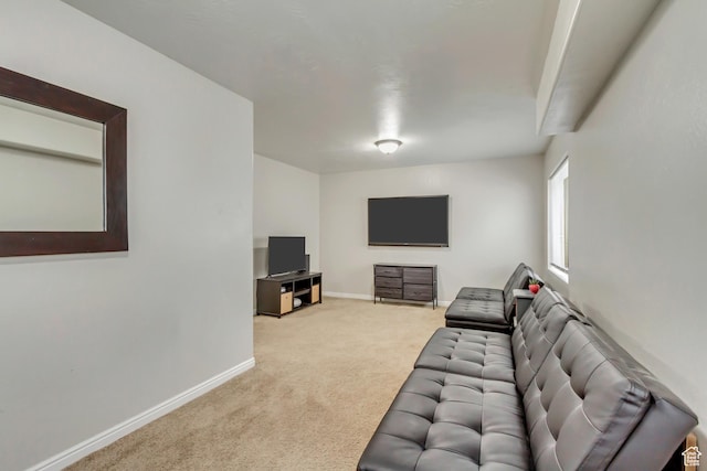 carpeted living area featuring baseboards