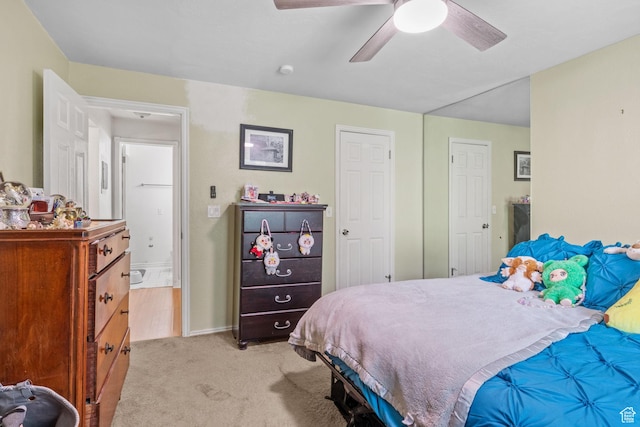 bedroom with light carpet, a ceiling fan, and baseboards