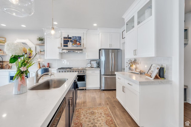 305 E 330 N, Vineyard, UT 84059 - kitchen with appliances with stainless steel finishes, a sink, light wood finished floors, tasteful backsplash, and recessed lighting
